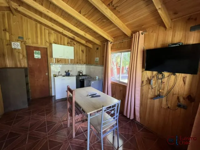 Cocina-comedor equipada con TV en cabaña de madera de Cabañas Mi Casa